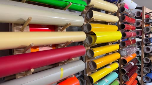 a wall full of various vinyl rolls in different colors